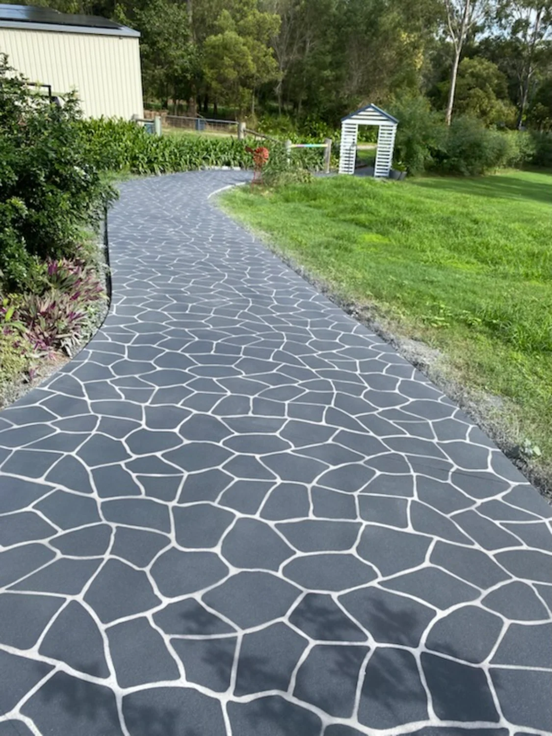 Grey patterned concrete footpath with clean edging and a professionally finished surface by Mark Holstein Concreting