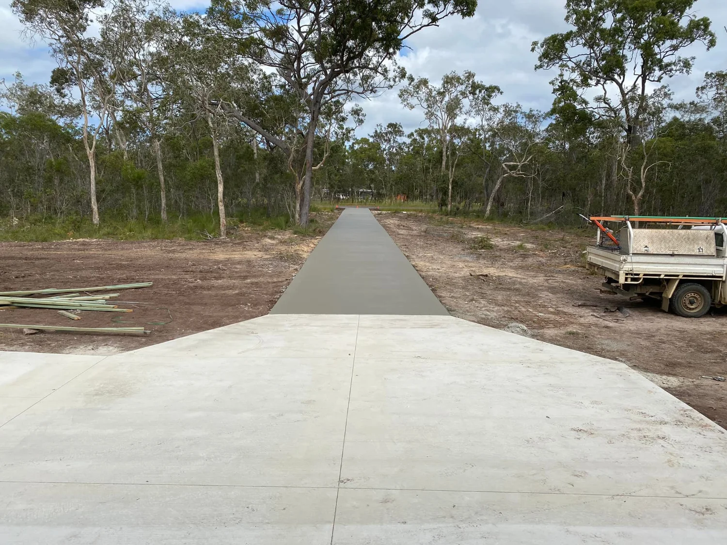 Fresh concrete driveway surrounded by gum trees demonstrating quality workmanship by Mark Holstein Concreting