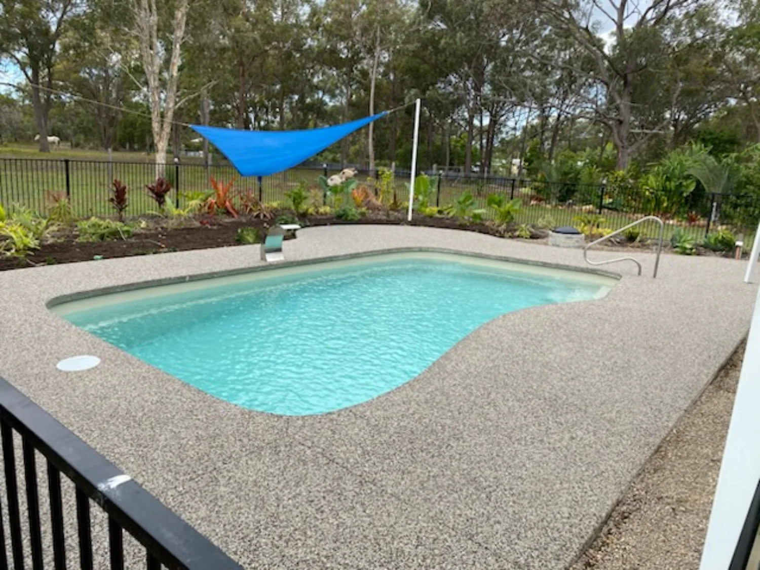 Completed aggregate concrete pool surrounds by Mark Holstein Concreting in Hervey Bay