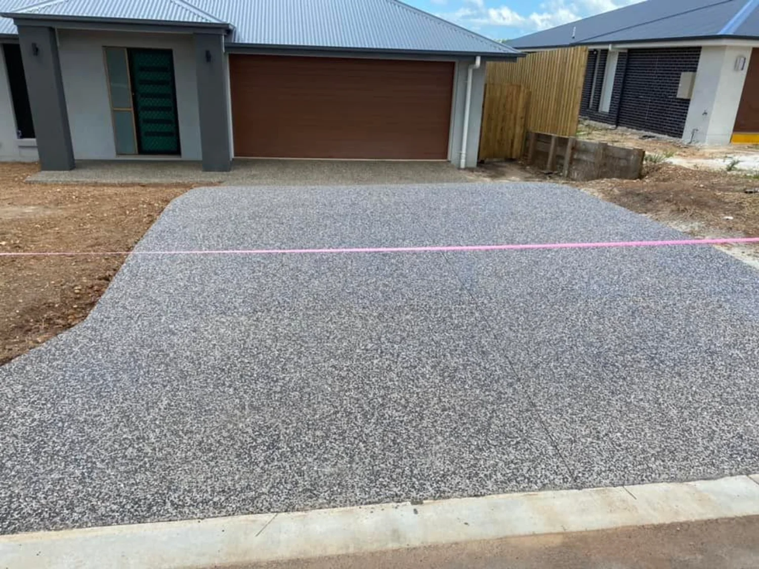 Exposed aggregate concrete driveway for a new build by Mark Holstein Concreting