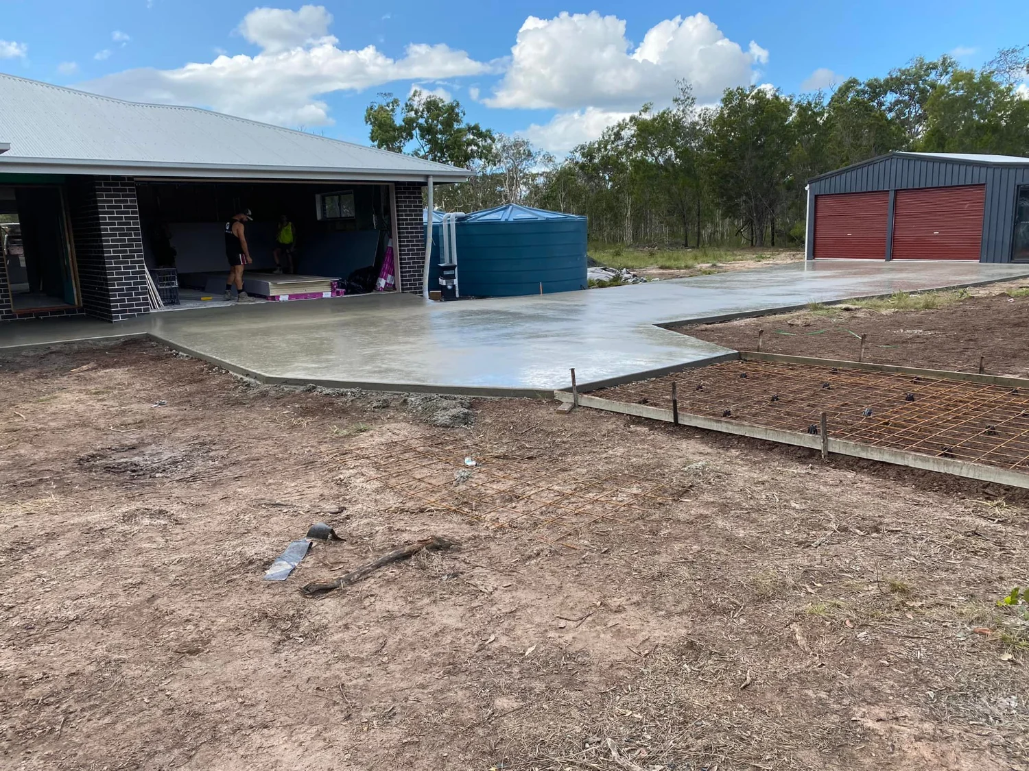 Freshly poured and levelled concrete driveway with reinforcing mesh by Mark Holstein Concreting in Hervey Bay